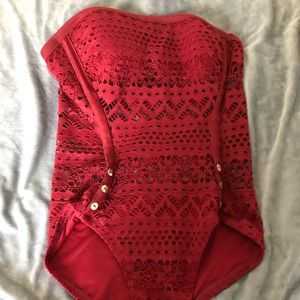 Maroon one piece swimsuit with straps.